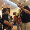 Mark O'Connor showing students his white fiddle he played to win all of those fiddle competitions!